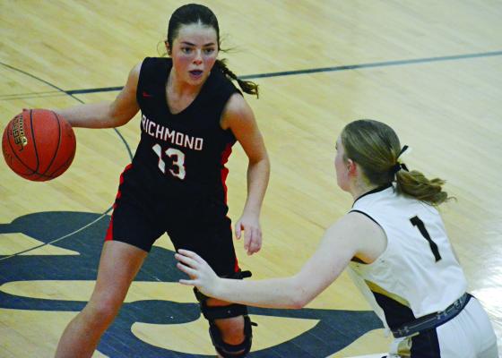RICHMOND JUNIOR Genevieve Didier dribbles and surveys the floor while guarded by Excelsior Springs junior Kayden Rogers in district title action. SHAWN RONEY | Staff