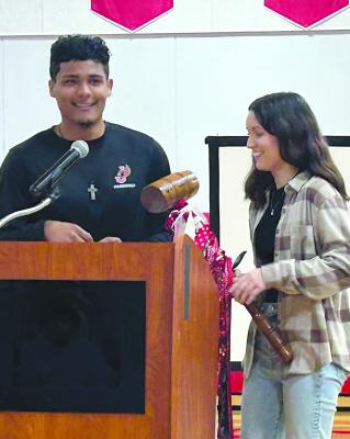 HAYDEN HAPPY passes the student council gavel to Alyana Quick. KAITLYN RIDDLE | Staff