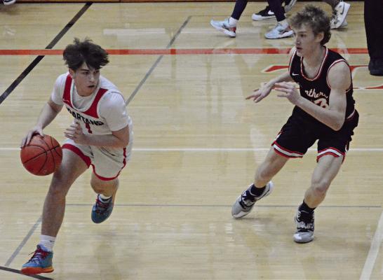 DRYDEN HENDRIX dribbles right for the Spartans during the first half of their Feb. 29 Class 4 District 15 Tournament semifinal meeting with Oak Grove at Oak Grove. SHAWN RONEY | Staff