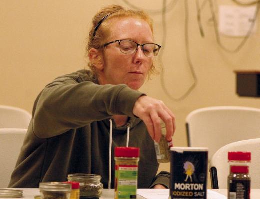 RACHELL BEACH combines herbs and salt while learning to make Greek seasoning. SHARON DONAT | Staff