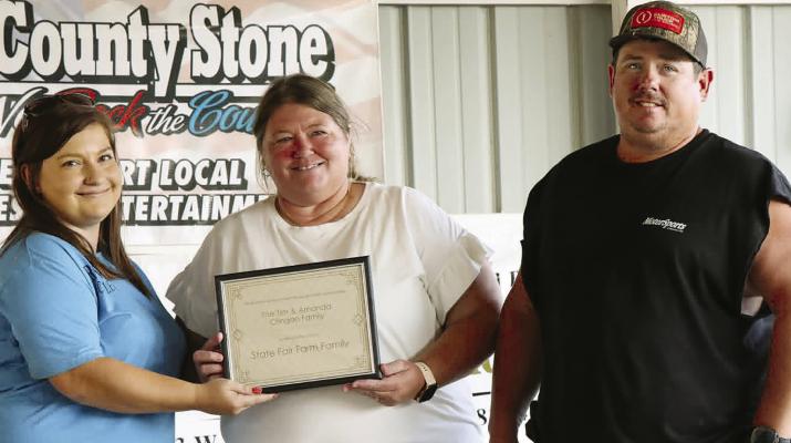 AMANDA (CENTER) AND TIM CRINGAN are recognized as Ray County’s 2026 Farm Family. The couple will represent the county during Farm Family Day at the Missouri State Fair on Aug. 17. Submitted