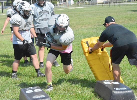 KOBE GIBSON, No. 11, swerves to his right to avoid a blocking dummy Aug. 18 on the practice fields at Hardin-Central. Gibson, a senior at Norborne, plays for the Norborne Hardin-Central co-op varsity 8-man football team. He and his fellow Aggies will open their regular season Friday at Sweet Springs. SHAWN RONEY | Staff