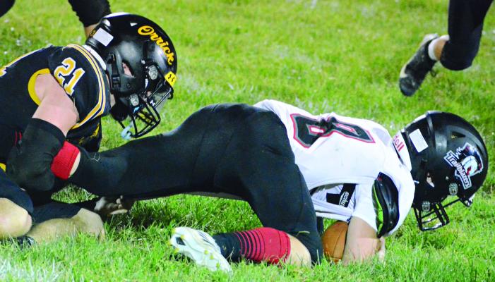 LUCAS WALKER (left) takes down Northland Christian’s Hudson Moss during the second half of Orrick’s seasonopening win. SHAWN RONEY | Staff