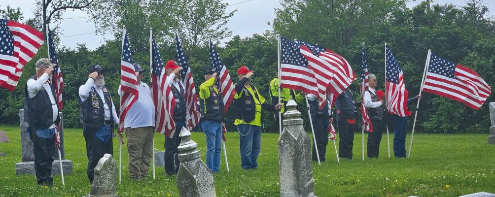 MILITARY VETERANS hold American flags and salute in honor of their fellow soldier Cpl. Charles Ryan Patten, who died in the Korean War. MIRANDA JAMISON | Staff