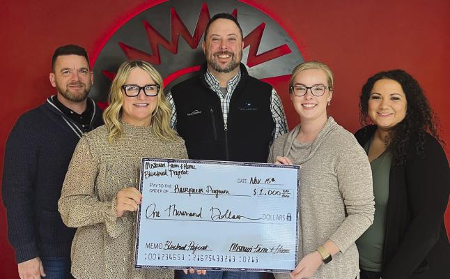 BLUEBIRD PROJECT members Mark McFee (from left), Amy Wirsig, Jimmy Carter, and Julia Landers gift a $1,000 check to Richmond R-XVI School District. Secretary Nicole Yoakum (far right) accepted the check on behalf of the district. SOPHIA BALES | Staff