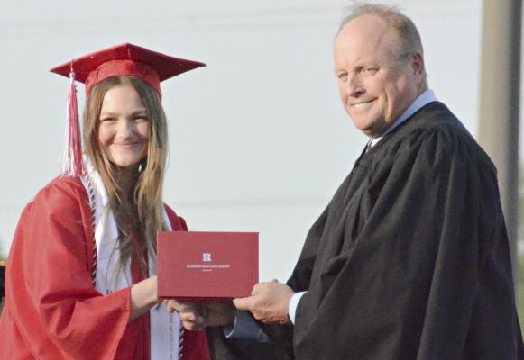 KATIE PIERSON (left), shown receiving her diploma from Richmond High School, is taking her softball skills to North Central Missouri College. SHAWN RONEY | Staff
