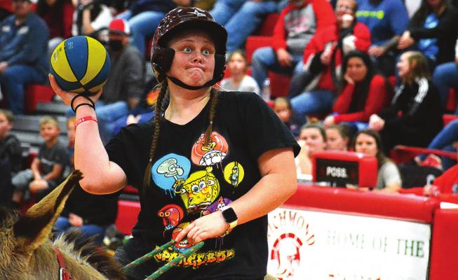 SENIOR LEXI BOKARAE, a three-sport athlete, tries her hand at donkey basketball March 21 in the Richmond High School Gym. SHAWN RONEY | Staff