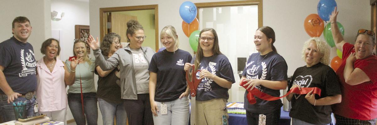 EMPLOYEES, COMMUNITY MEMBERS and chamber representatives celebrate Central Missouri Community Credit Union’s 65th anniversary with a ribbon-cutting, recognizing its continued commitment to the communities it serves. SHARON DONAT | Staff