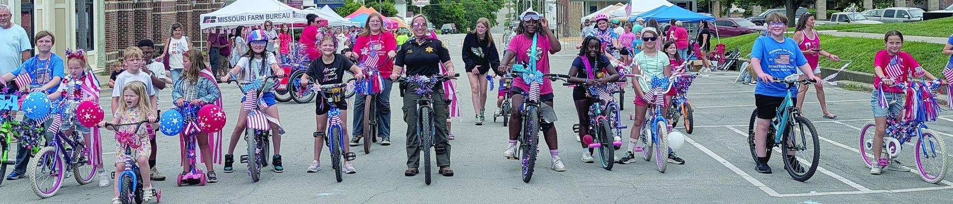 CHILDREN AND FAMILIES pedal decorated bicycles through downtown Richmond while judges assess entries in various categories during the America 250th Celebration. Participants decorated their bikes with patriotic ornaments before traveling the route. MIRANDA JAMISON | Staff