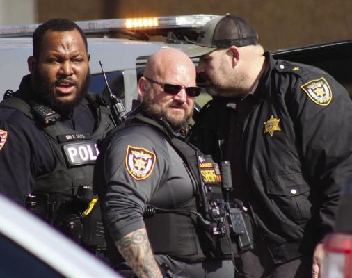 RICHMOND POLICE Officer Romulus Davis (from left), Ray County Sheriff Deputy Brian Lackey and Ray County Sheriff Scott Childers assist in the arrest of Brenden Parsons. SOPHIA BALES | Staff