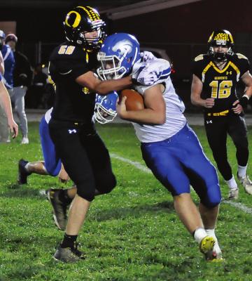 SENIOR MASON FURNER goes high as he attempts to make a second-quarter tackle for Orrick during the Bearcats’ 60-22 District 3 Tournament victory over Southwest/Hale/Tina-Avalon on Nov. 5 at Simmons Field. SHAWN RONEY | Staff