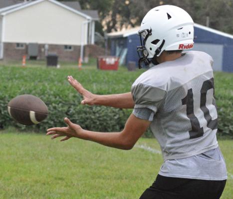 WYATT DOOLEY follows the ball into his hands during a receiving drill at a Norborne Hardin-Central team camp session for high schoolers. SHAWN RONEY | Staff