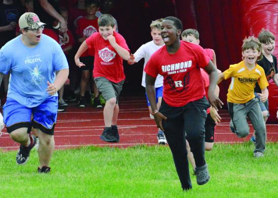 SEBASTIAN SVEISTRUP (front, left) and Savion Webb lead some youngsters through an inflated tunnel onto Tom Adams Field at Spartan Stadium on the final day of Richmond’s two-day youth football camp, overseen by Richmond varsity football coach Nick Persell. Look for additional coverage May 30. SHAWN RONEY | Staff