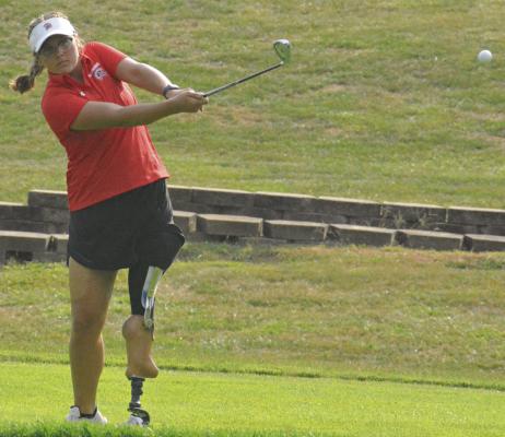 SHAWN RONEY | Staff ISABELLA SMITH watches her chip shot during Richmond’s recent road quadrangular with Excelsior Springs, Norborne and Lawson.