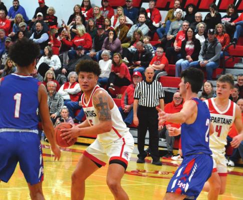 SENIOR KEYSHAUN ELLIOTT surveys the floor from around the free throw line during the Spartans’ 57-38 courtwarming win Feb. 11 over Lexington. SHAWN RONEY | Staff