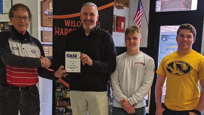 KIRK THACKER displays his Dream Team 8-Man Football Coach of the Year award from Joe Aull of KMZU. Others, from left, are two of his Norborne Hardin-Central Aggies, Mason McCaulley and Nate Hawkins. SUBMITTED PHOTO