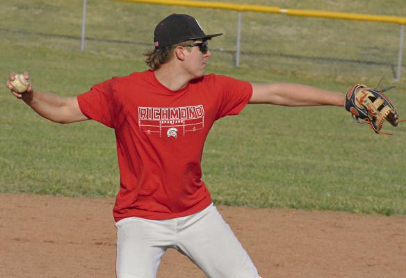RICHMOND JUNIOR Conner Rodenberg looks to throw to first base during baseball practice.