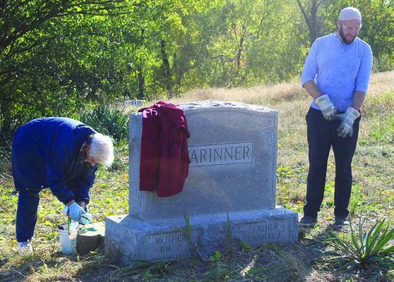 KAY BARCHERS (left) applies herbicide to freshly cut tree stump with James Evans.