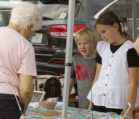 RYANN MADGET (right) helps customers browse the selection of handmade items available at her Ryann’s Razzle Dazzle booth. See page 8 for more young entrepreneurs. MIRANDA JAMISON | Staff