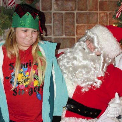SOPHIA BALES | Staff LACI KINGERY talks with Mr. Claus about gifts this Christmas.