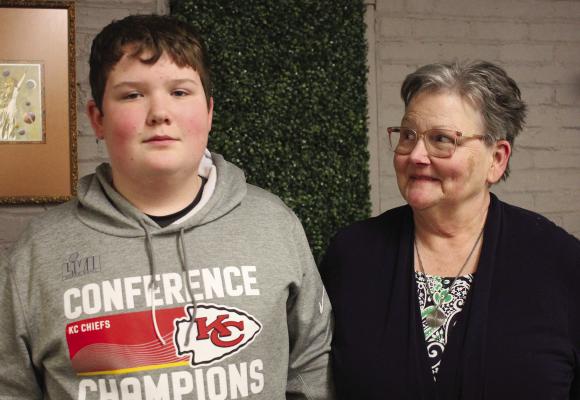 CASH ADAMS, 13, and his grandmother Mary Adams (right) appreciate the community’s support with his injury after the Chiefs rally. SOPHIA BALES | Staff