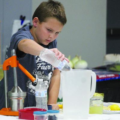 EVERETT SCHWAB prepares a batch of homemade lemonade during his demonstration.