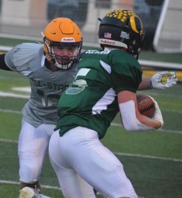 PLAYING DIFFERENT positions than usual, Orrick graduate Blake Buchanan displays his receiving skills during this catch-and-run play in 8-man all-star football action ... SHAWN RONEY | Staff