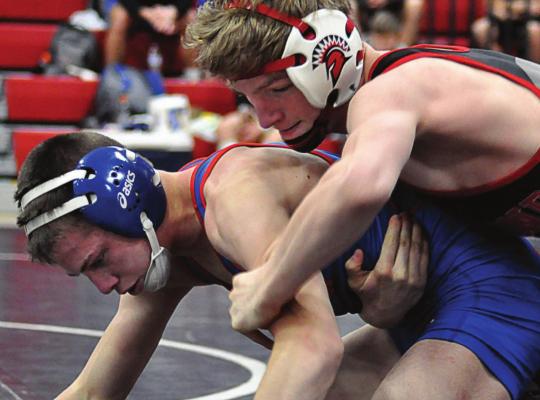 RICHMOND JUNIOR Conner Teat, top, looks to break down Lexington’s Josh Payne in the Missouri River Valley Conference East Division Tournament. SHAWN RONEY | Staff