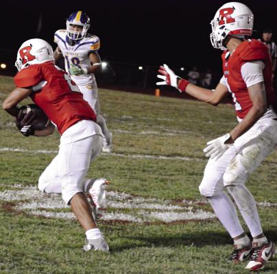 AFTER MAKING A one-handed catch, senior Cyrus Jackson (left) secures the football with both hands and races downfield with teammate Brice Dome watching during Richmond’s homecoming victory over Center. SHAWN RONEY | Staff
