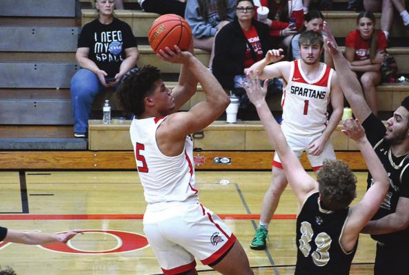 RICHMOND SENIOR Keyshaun Elliott leans back as he attempts a second-half midrange jump shot during the Spartans’ Class 4 District 15 Tournament victory Tuesday night over Excelsior Springs at Oak Grove. SHAWN RONEY | Staff
