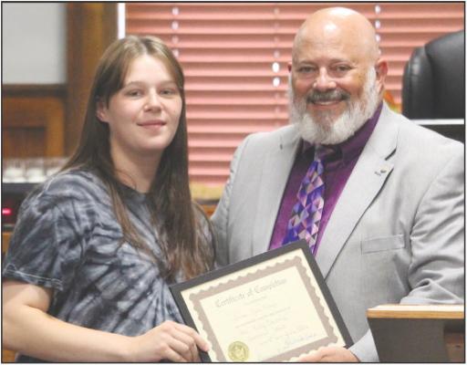 JENNA FISHER (left) receives her Ray County Drug Court graduation certificate from Eighth Judicial Circuit Court Judge Kevin Walden during the program’s 43rd graduation ceremony. MIRANDA JAMISON | Staff