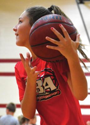 RICHMOND MIDDLE SCHOOLER Adilyn Swope collects a rebound after a missed shot and looks toward the hoop Monday during basketball camp. SHAWN RONEY | Staff