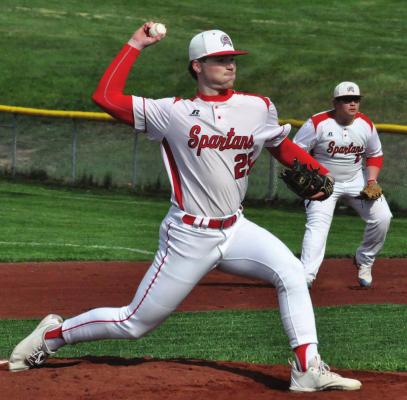 JUNIOR PITCHER Lucas Rodenberg strides toward home plate as he prepares to delivers the pitch. Behind him, junior first baseman Trey Duncan stands ready to make a play Monday afternoon against visiting St. Michael the Archangel at Southview Park. SHAWN RONEY | Staff