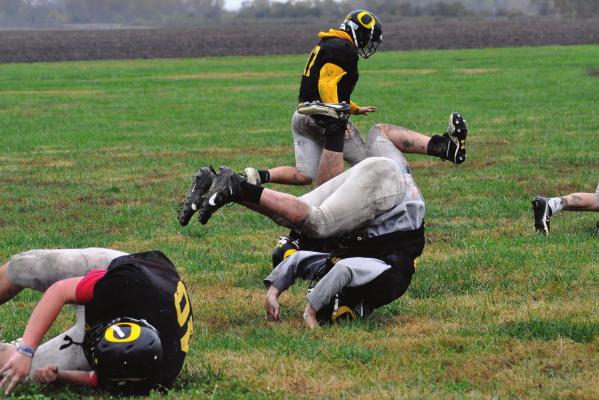 THE BEARCATS do forward rolls as they work on their agility and conditioning on a cold, rainy Monday afternoon on the Orrick 8-man football practice field. SHAWN RONEY | Staff