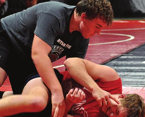SENIORS ZANE RENFRO, top, and Ryker Plymell, seen practicing their wrestling moves, are looking to return to state competition for the Spartans. SHAWN RONEY | Staff