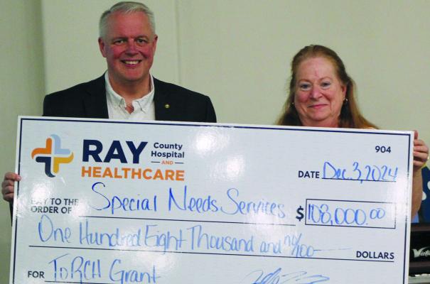 RAY COUNTY HOSPITAL and Healthcare CEO Jeff Bloemaker (left) presents a $108,000 check to SNS Executive Director Suzan Breen to help fund the new program. SHARON DONAT | Staff