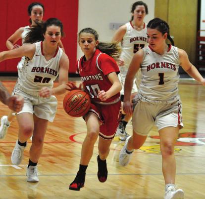 THE HORNETS display the defensive skills that make them the kind of ballclub the Spartans want to be. The Hornets swarm around Richmond freshman Kaylee Pugh on Tuesday in Lawson Invitational play. SHAWN RONEY | Staff