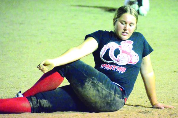 AIREANNA HOEPPNER stretches in the wee hours of Monday morning at Southview Park as she participates in the final midnight practice of her high school softball career at Richmond. SHAWN RONEY | Staff