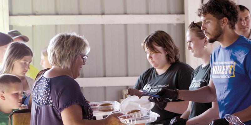 VOLUNTEERS SERVE FARM families a meal during the Farmers Appreciation Dinner.