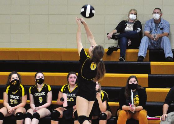 JUNIOR ANNIKA PARKER fights to keep the volleyball in play by bumping it back over her head Monday during Orrick’s non-conference meeting with visiting Mid-Buchanan. SHAWN RONEY | Staff