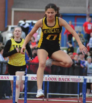 FIRST-YEAR high schooler Anela Fletcher goes airborne in the home stretch of the girls 300-meter intermediate hurdles Tuesday at Lexington.