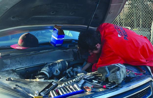 A RAY COUNTY Jail inmate works on a vehicle inside the gated area behind the jail. SOPHIA BALES | Staff