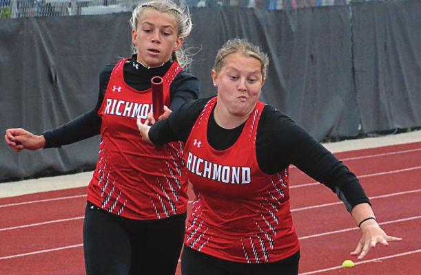 MACKENZEY PEACH reaches back to grab the baton from Kaylee Pugh during the girls 400-meter relay May 21 at sectionals in Odessa. SHAWN RONEY | Staff
