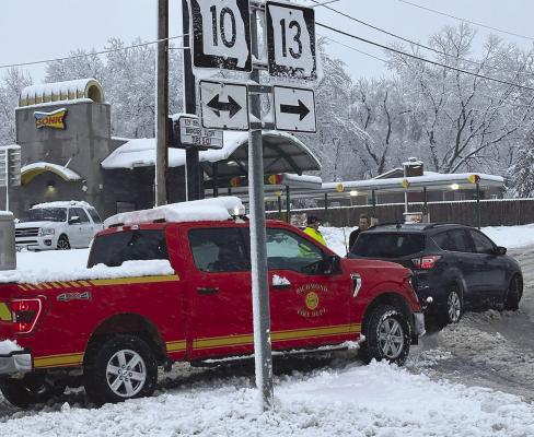 FIRE CHIEF Mark Sowder talks to the driver of a vehicle experiencing problems getting up the slight incline in front of Sonic. ROBBIE FARABEE | Submitted