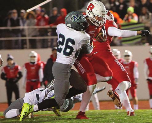 RICHMOND quarterback Keyshaun Elliott rushes for four touchdowns in the District 8 championship game, including busting one for 91 yards. Here he is brought down, with a back-bending opposition effort, after a 33-yard pickup. J.C. VENTIMIGLIA | Staff