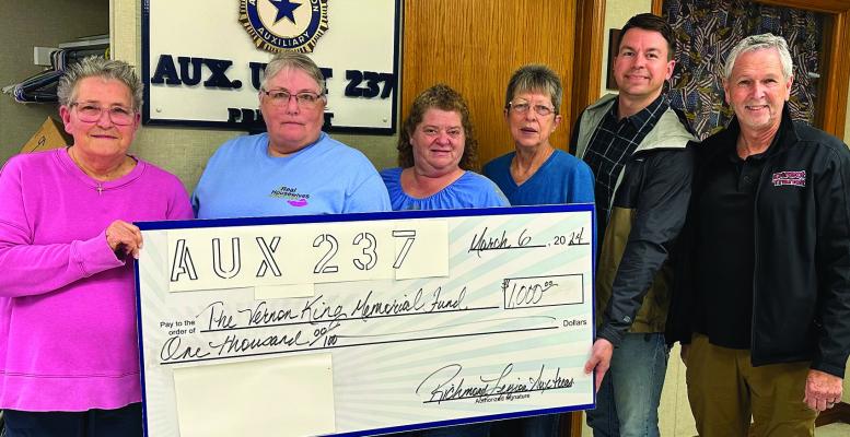 VICKEY EDWARDS (from left), Sally Foley, Rachelle Green and Brenda Richardson of Richmond Legion Auxiliary 237 award $1,000 to Chris Ring and Brad Marroitt of the Vernon King Memorial Foundation. This foundation covers transportation costs for local veterans. Read about it in the next edition of Richmond News. Submitted