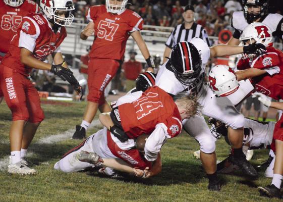 SHAWN RONEY | Staff RICHMOND FIRST-YEAR high schooler Nolan Quick shows he can take a hit as his helmet flies off during a secondhalf rushing attempt Sept. 9 against visiting Marshall.