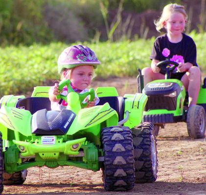 KAMERYN WILLIAMS races ahead of Kameryn Chowning during the first-ever Power Wheels racing event at the fairgrounds. SHARON DONAT | Staff