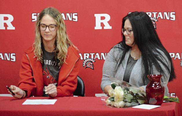RICHMOND SENIOR Kaylee King (left) signs her letter of intent to study at and compete in women’s track and field for the University of Central Missouri in Warrensburg as her mother, Debbie Rosse, watches. Look for additional coverage April 11. SHAWN RONEY | Staff