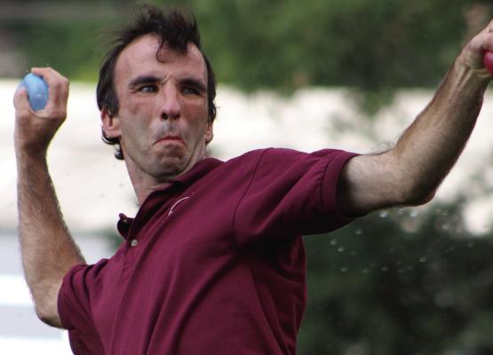 TIM JENKINS WINDS up to launch a water balloon during Community At Play’s annual water fight event. SHARON DONAT | Staff